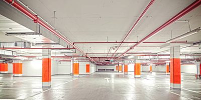 Retro filtered photo of underground parking, industrial interior.